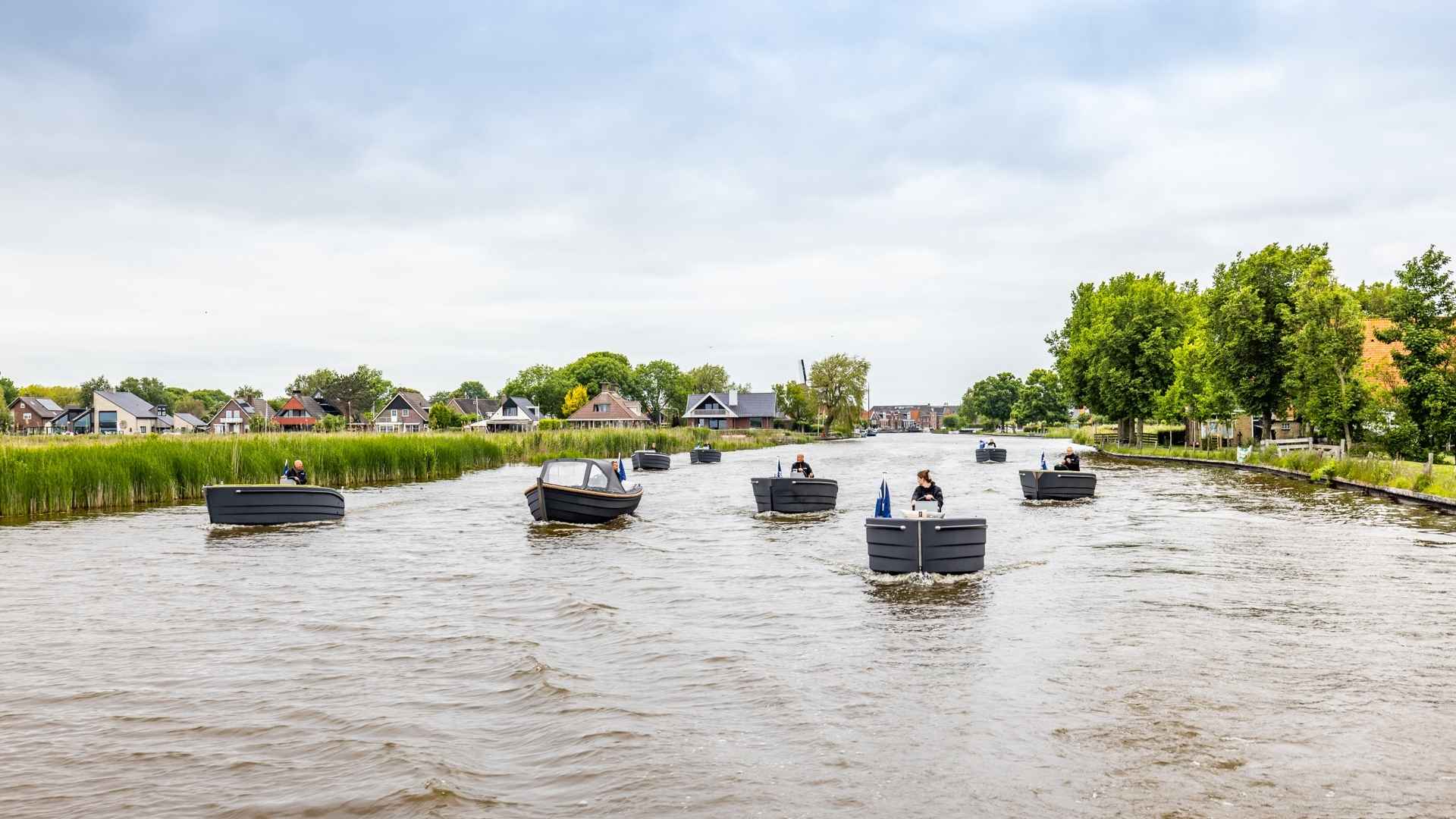 Nine 3D-printed sloops on the water, cruising in Woudsend, Netherlands